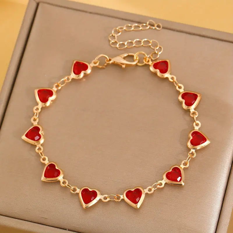 Bracelet chaîne en or avec cœur en rubis