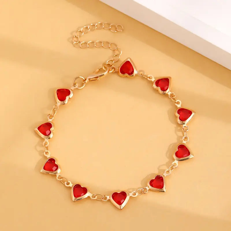 Bracelet chaîne en or avec cœur en rubis