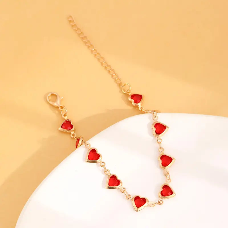Bracelet chaîne en or avec cœur en rubis