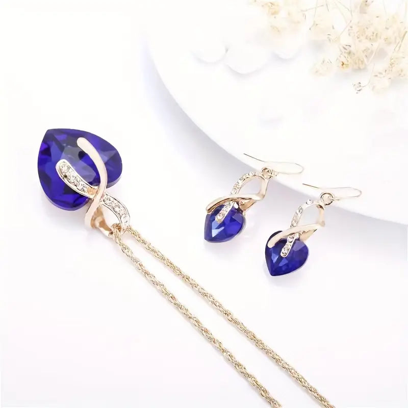 Ensemble collier et boucles d’oreilles en or avec cœur en saphir